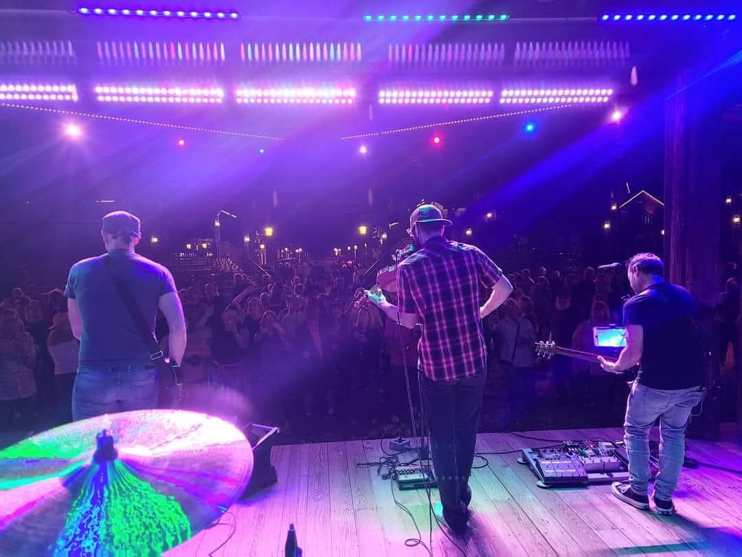 Greg Warren Band playing live on stage with purple and blue concert lighting